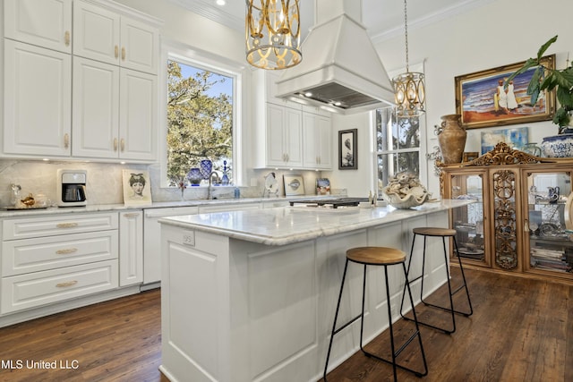 kitchen featuring premium range hood, a kitchen bar, dark wood finished floors, and crown molding