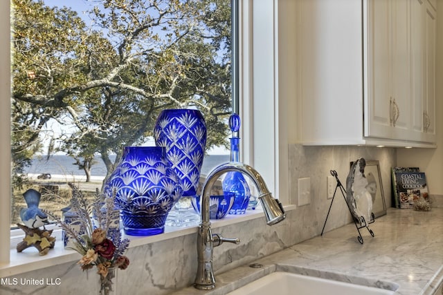 room details with a sink and light stone countertops