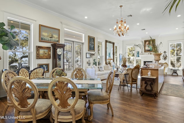 dining space with dark wood-type flooring, a fireplace, and ornamental molding