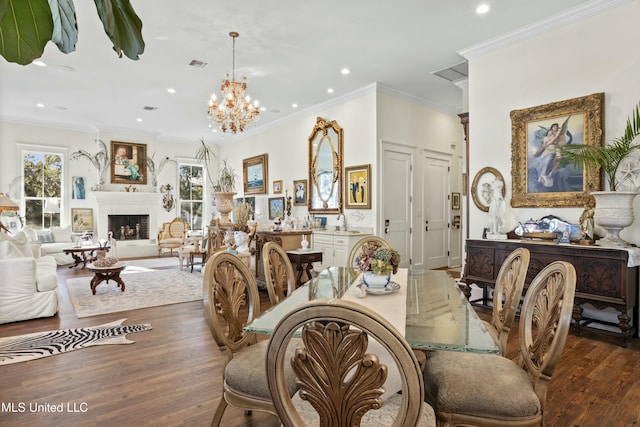 dining space with a wealth of natural light, visible vents, a fireplace with raised hearth, and wood finished floors