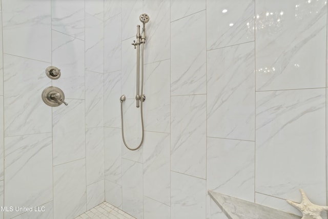 bathroom with tiled shower