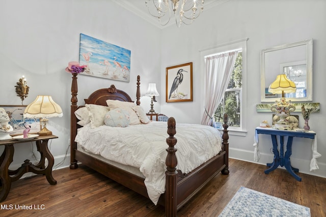 bedroom featuring a notable chandelier, crown molding, baseboards, and wood finished floors