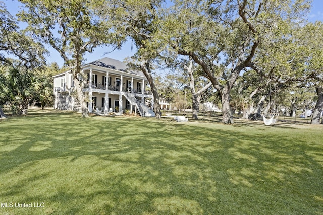 exterior space featuring a front yard and stairs