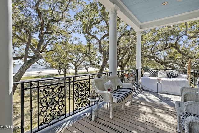 wooden terrace with an outdoor living space