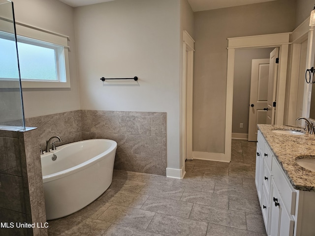 3545 Bailey Ln, Southaven, MS 38672 - full bath with a freestanding bath, double vanity, and tile walls