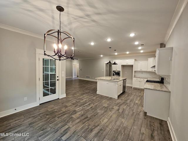 3545 Bailey Ln, Southaven, MS 38672 - kitchen featuring ornamental molding, open floor plan, a sink, a chandelier, and dark wood-style floors