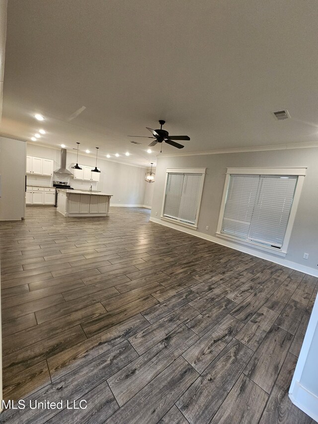 3545 Bailey Ln, Southaven, MS 38672 - unfurnished living room with a ceiling fan, dark wood-type flooring, recessed lighting, ornamental molding, and baseboards
