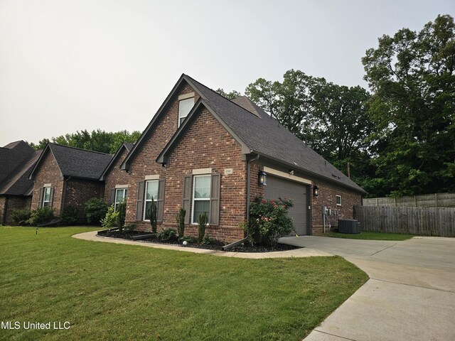 3545 Bailey Ln, Southaven, MS 38672 - craftsman inspired home featuring driveway, brick siding, an attached garage, roof with shingles, and central AC