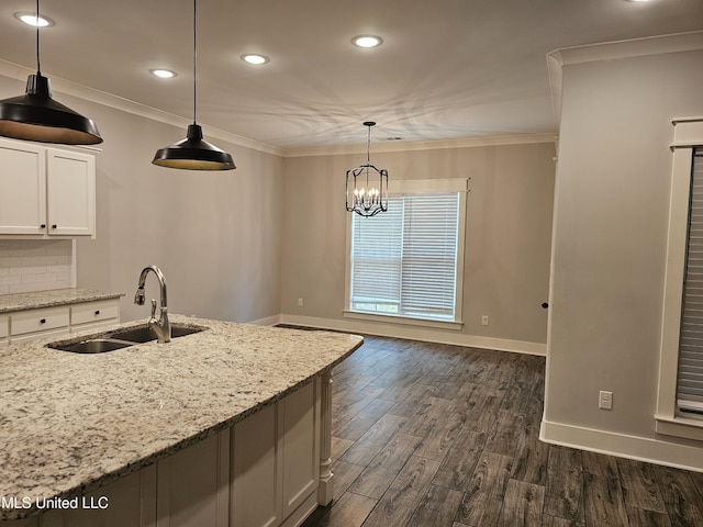 3545 Bailey Ln, Southaven, MS 38672 - kitchen with a sink, baseboards, dark wood finished floors, white cabinets, and ornamental molding