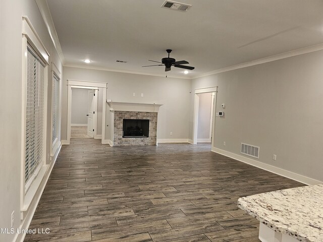 3545 Bailey Ln, Southaven, MS 38672 - unfurnished living room with ceiling fan, crown molding, baseboards, dark wood-style flooring, and a fireplace