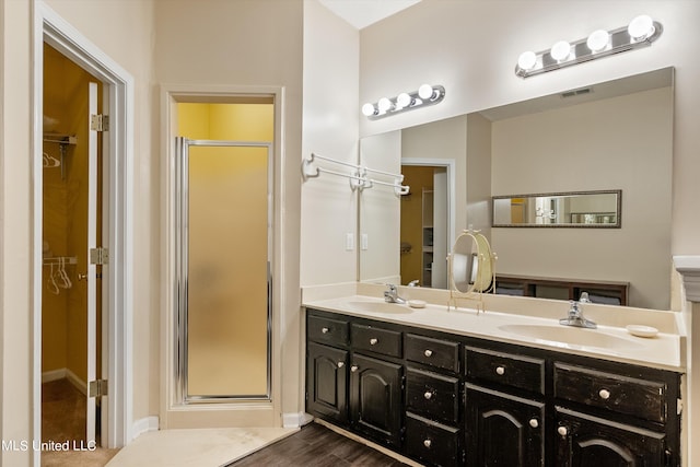 bathroom featuring vanity, walk in shower, and hardwood / wood-style floors