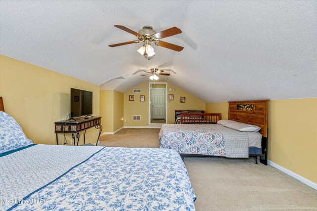 carpeted bedroom featuring a textured ceiling, vaulted ceiling, and ceiling fan