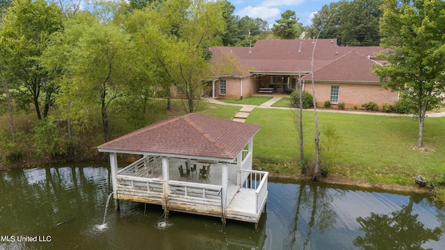 view of dock with a gazebo, a yard, and a water view