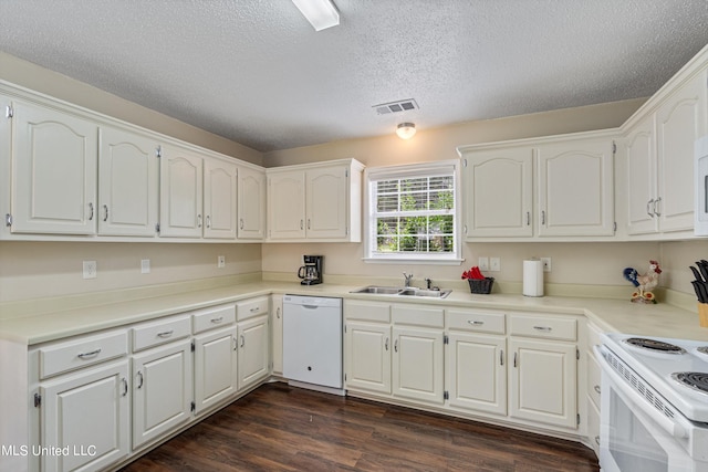 kitchen featuring dark hardwood / wood-style flooring, white cabinets, sink, and white appliances