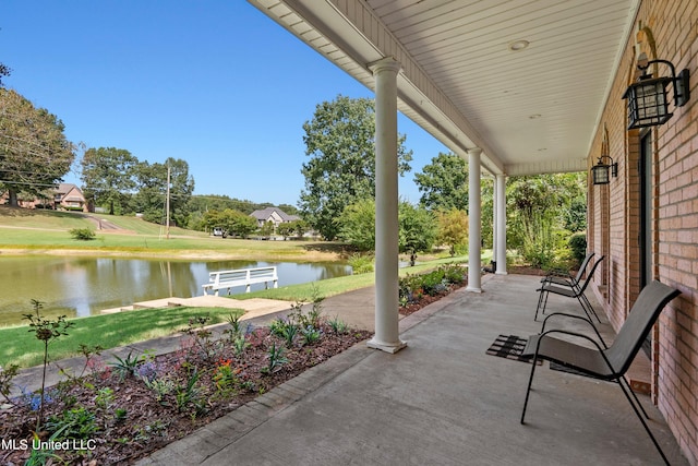 view of patio featuring a water view and a porch