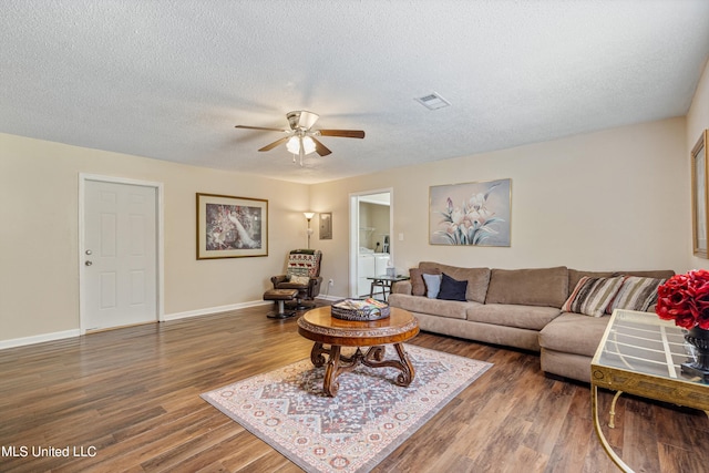 living room with ceiling fan, a textured ceiling, and dark hardwood / wood-style flooring