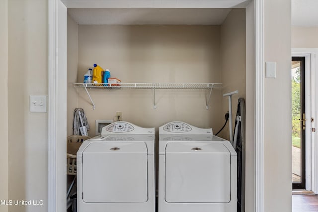 laundry room featuring hardwood / wood-style floors and washer and clothes dryer