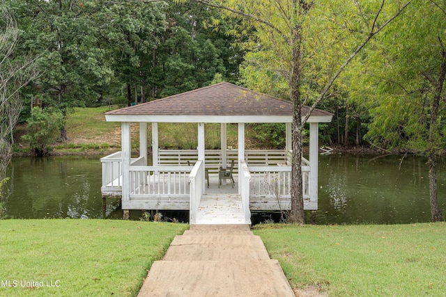 view of dock with a gazebo, a yard, and a water view