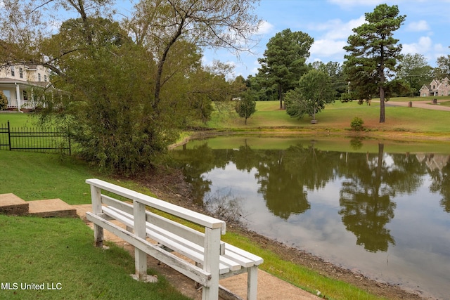 view of property's community featuring a water view and a lawn