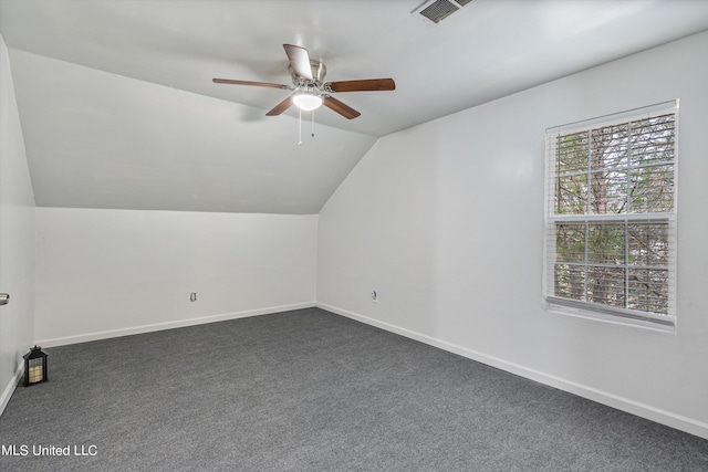 bonus room featuring lofted ceiling, dark colored carpet, and ceiling fan