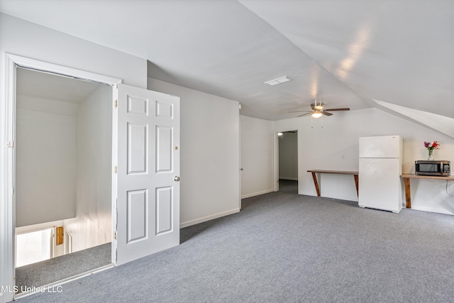 bonus room featuring lofted ceiling, carpet flooring, and ceiling fan