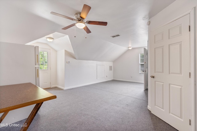 additional living space featuring ceiling fan, dark carpet, and vaulted ceiling