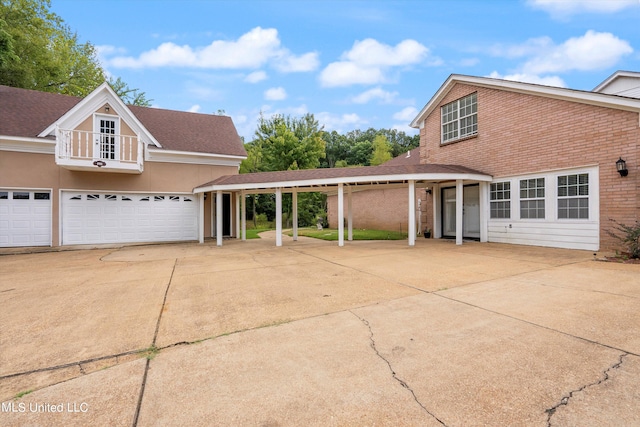 front of property with a garage and a carport