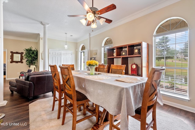 dining room featuring crown molding, decorative columns, wood-type flooring, and ceiling fan