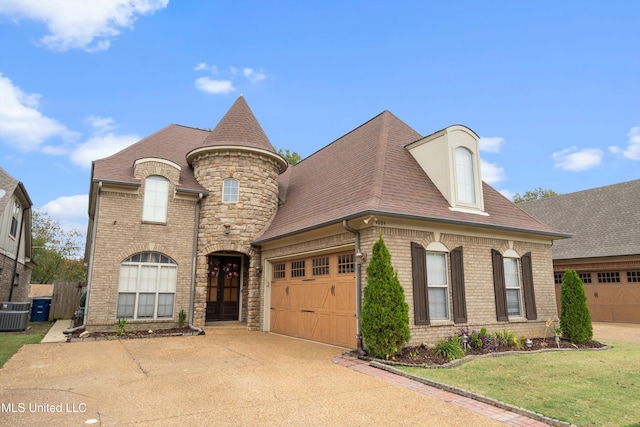 view of front of home with a front lawn and a garage