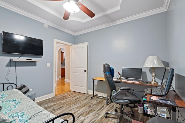 office space with ornamental molding, light wood-type flooring, and ceiling fan