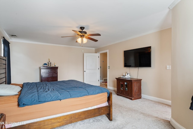 carpeted bedroom featuring ceiling fan and crown molding