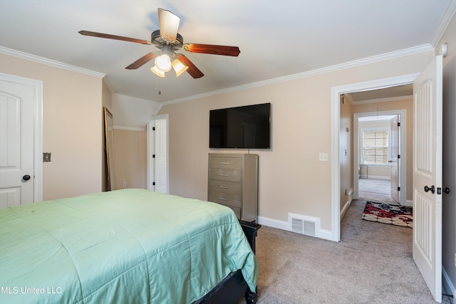 carpeted bedroom with ceiling fan and crown molding