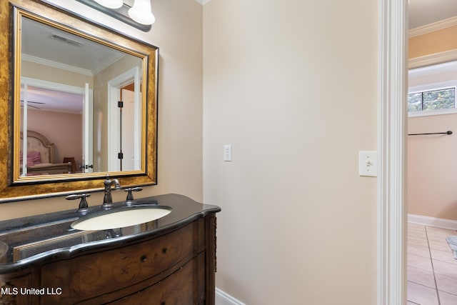 bathroom with ornamental molding, vanity, and tile patterned floors