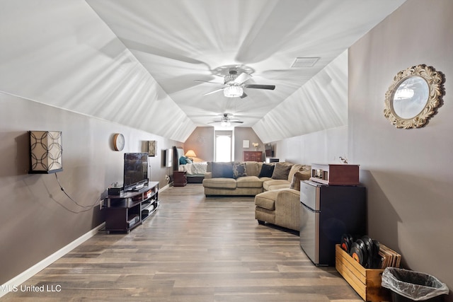 living room featuring hardwood / wood-style floors, ceiling fan, and vaulted ceiling