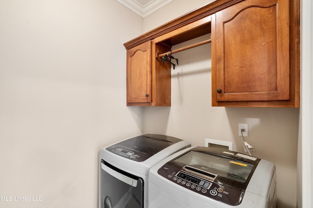 laundry room featuring cabinets, washer and clothes dryer, and ornamental molding