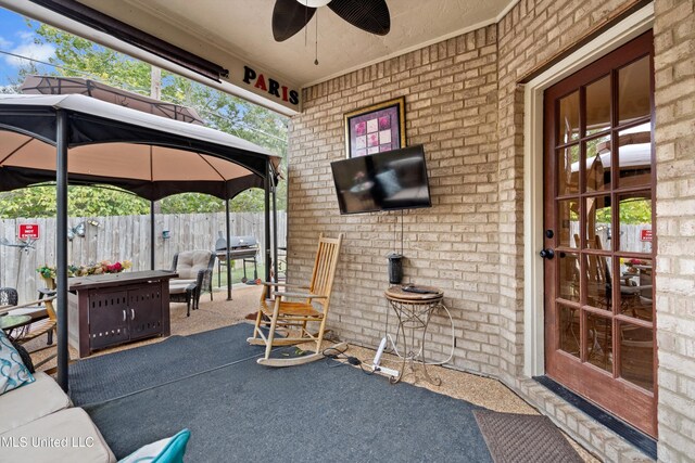 view of patio / terrace with ceiling fan and a gazebo