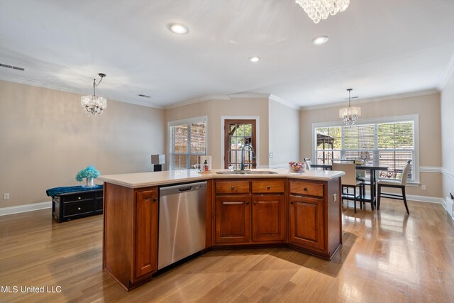 kitchen with stainless steel dishwasher, pendant lighting, an inviting chandelier, and a kitchen island with sink