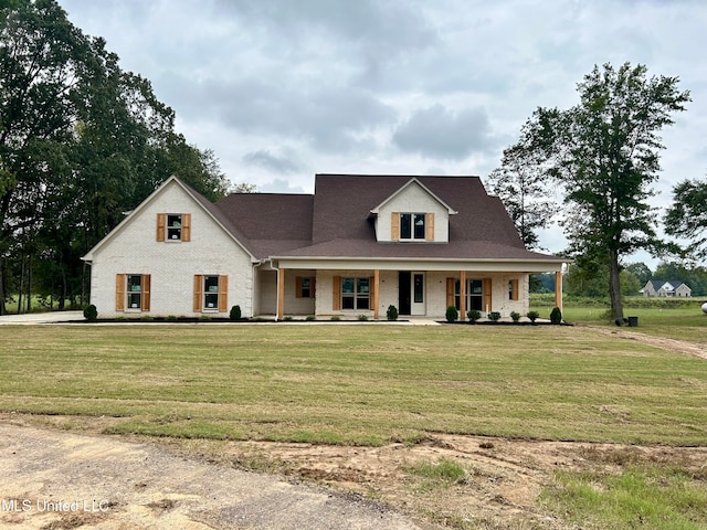 view of front of home with a porch and a front yard