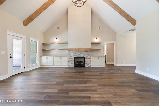 13721 Pebble Ridge Dr, Byhalia, MS 38611 - unfurnished living room featuring high vaulted ceiling, dark wood-type flooring, beamed ceiling, baseboards, and a tile fireplace