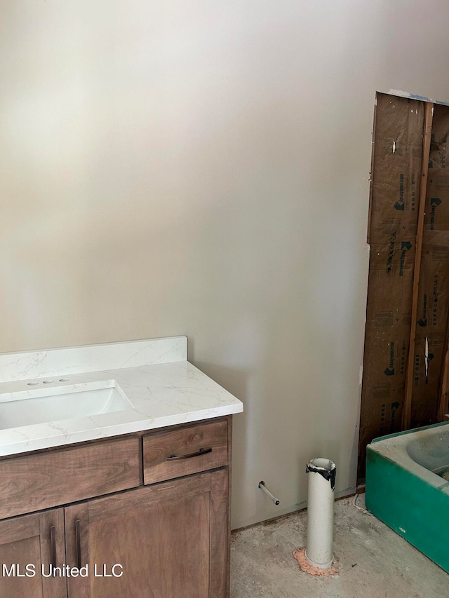 bathroom featuring vanity and unfinished concrete floors