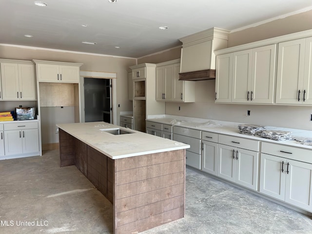 kitchen with an island with sink, light stone countertops, concrete flooring, and premium range hood