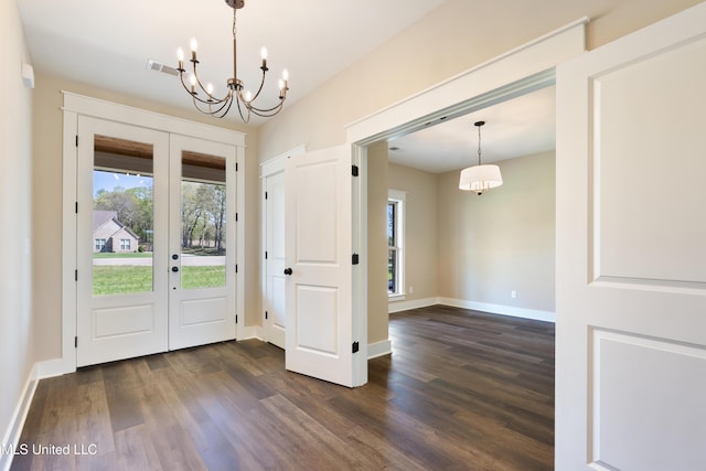 13721 Pebble Ridge Dr, Byhalia, MS 38611 - entrance foyer featuring a chandelier, dark wood-type flooring, french doors, and baseboards