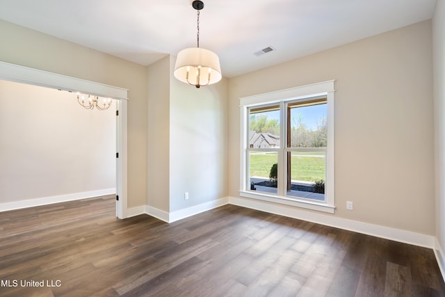 13721 Pebble Ridge Dr, Byhalia, MS 38611 - unfurnished dining area featuring a chandelier, dark wood finished floors, and baseboards