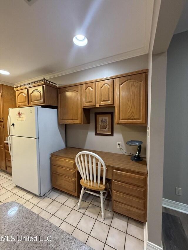 518 Main St, Natchez, MS 39120 - kitchen with freestanding refrigerator, crown molding, and light tile patterned floors