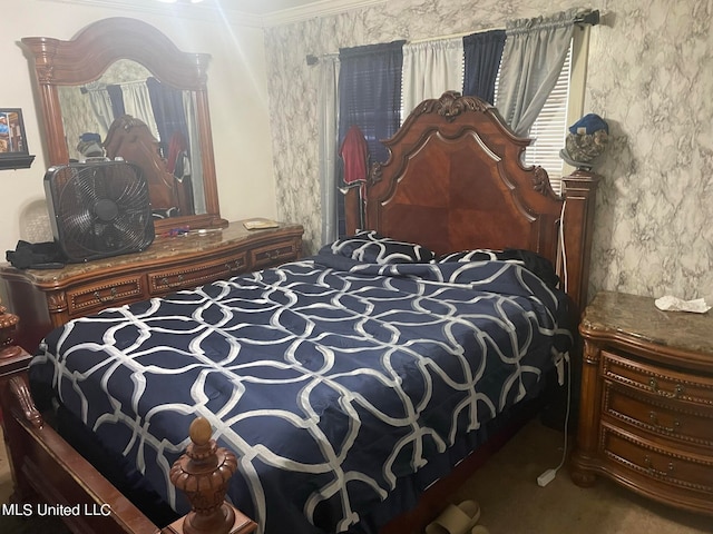 bedroom with crown molding and carpet floors