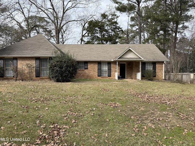 single story home featuring a front lawn