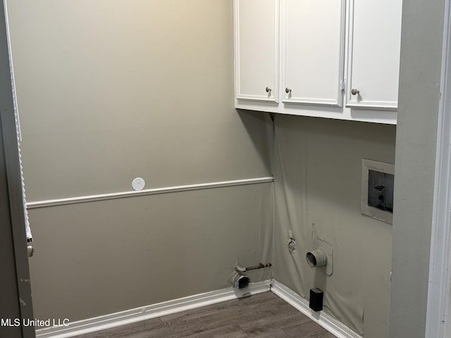 laundry room featuring dark wood-type flooring, hookup for a washing machine, cabinets, and gas dryer hookup