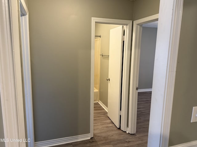 corridor with wood-type flooring