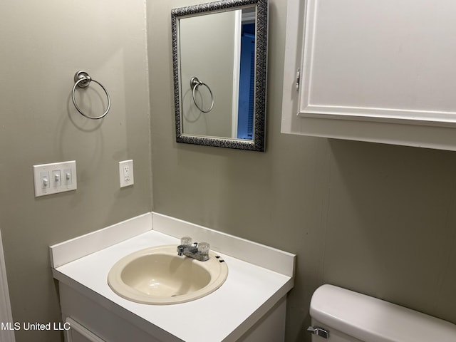 bathroom featuring toilet and vanity