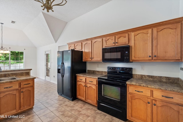 kitchen with black appliances, dark countertops, a sink, brown cabinets, and lofted ceiling